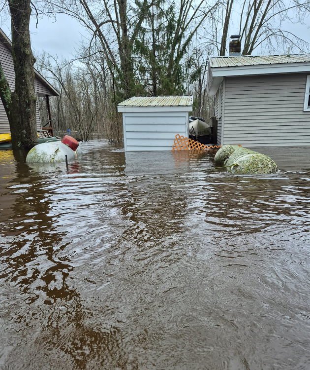 propane tanks floating in flooded residential yard after storm - propane tank safety tips